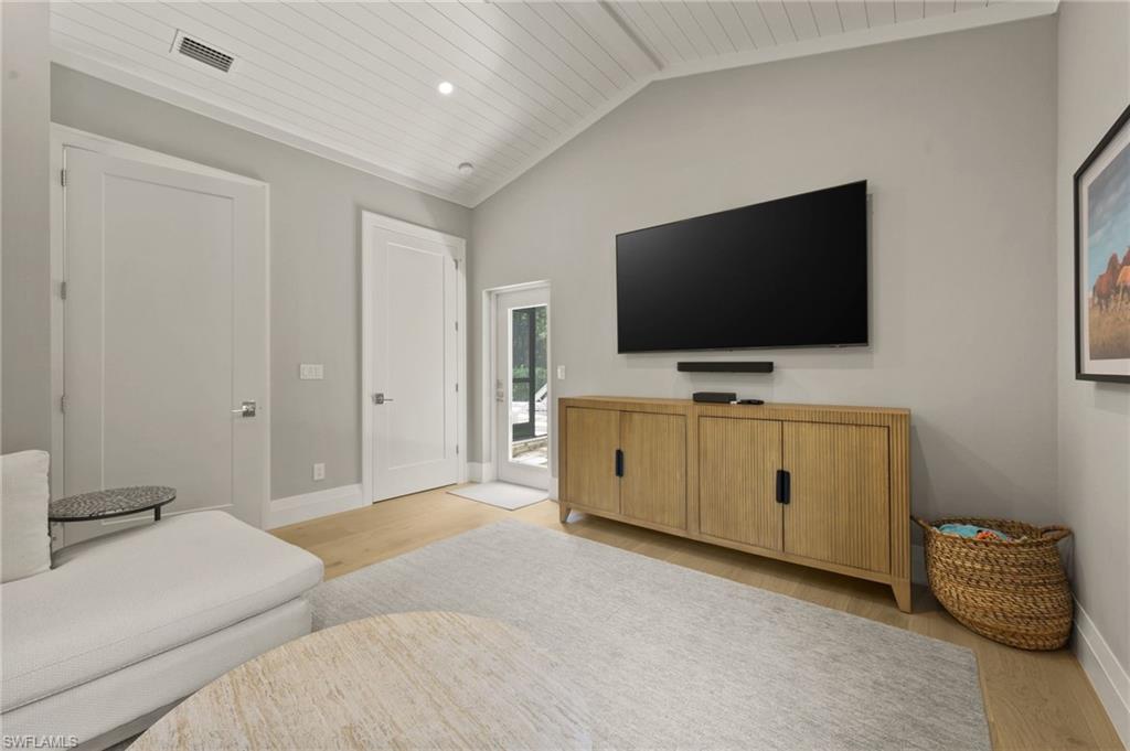 6689 Mill Run Road Naples, FL 34109 - Photo 33 of 37 a bedroom with furniture and a flat screen tv
