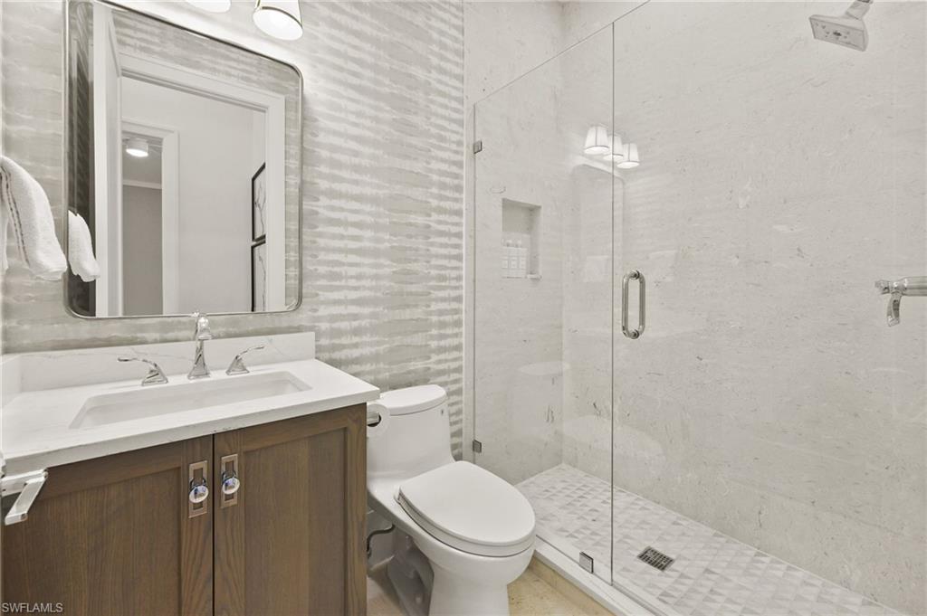 6689 Mill Run Road Naples, FL 34109 - Photo 35 of 37 a bathroom with a sink toilet and shower