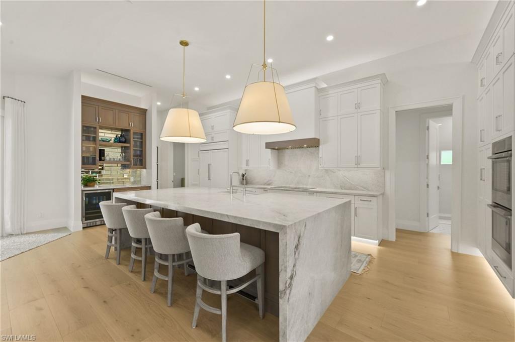 6689 Mill Run Road Naples, FL 34109 - Photo 5 of 37 a kitchen with a table and chairs in it