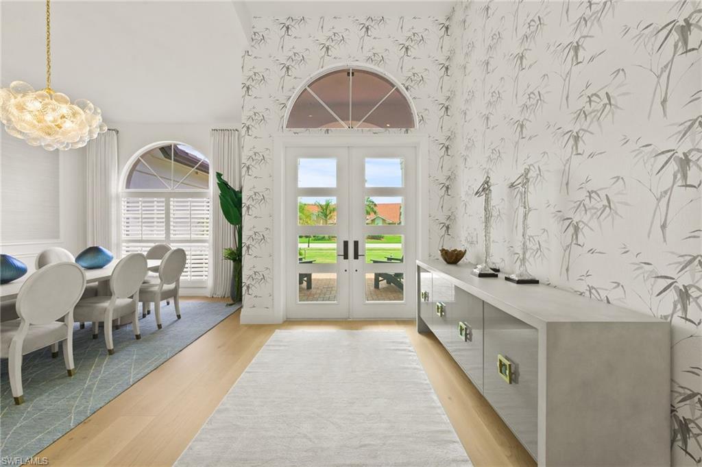 6689 Mill Run Road Naples, FL 34109 - Photo 8 of 37 a large white kitchen with a large window