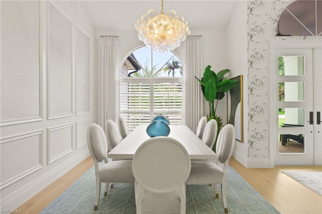 6689 Mill Run Road Naples, FL 34109 - Photo 9 of 37 a view of a dining room with furniture window and wooden floor