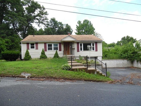 135 Columbia Road Lowell, MA 01854 - Photo 1 of 12 a white house that has a tree in front of it