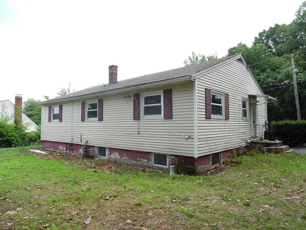 135 Columbia Road Lowell, MA 01854 - Photo 2 of 12 a front view of a house with a garden