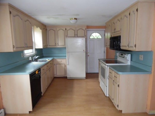 135 Columbia Road Lowell, MA 01854 - Photo 3 of 12 a kitchen with stainless steel appliances granite countertop a refrigerator a stove a sink and a microwave