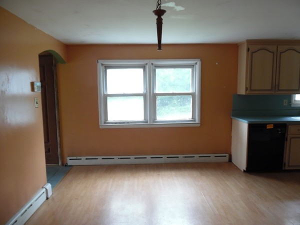 135 Columbia Road Lowell, MA 01854 - Photo 4 of 12 a view of a livingroom with an empty space and a window
