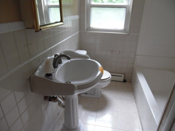 135 Columbia Road Lowell, MA 01854 - Photo 5 of 12 a bathroom with a toilet sink and mirror