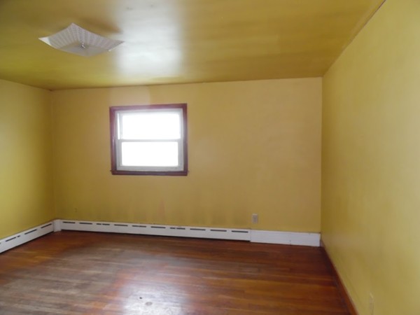 135 Columbia Road Lowell, MA 01854 - Photo 8 of 12 a view of a room with wooden floor and fence