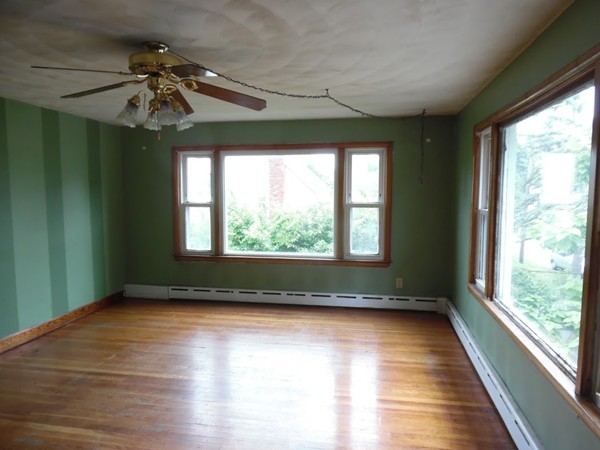 135 Columbia Road Lowell, MA 01854 - Photo 9 of 12 a view of room with window chandelier and wooden floor