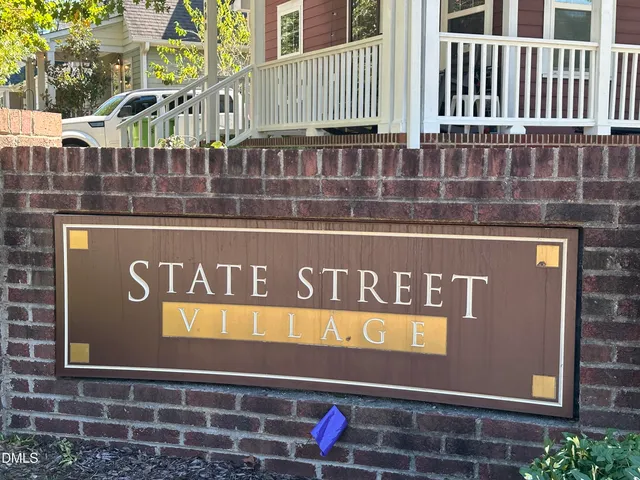 a street sign on a wall next to a building