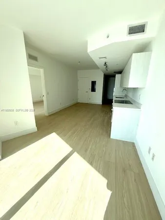 a view of a kitchen with a sink and a wooden floor