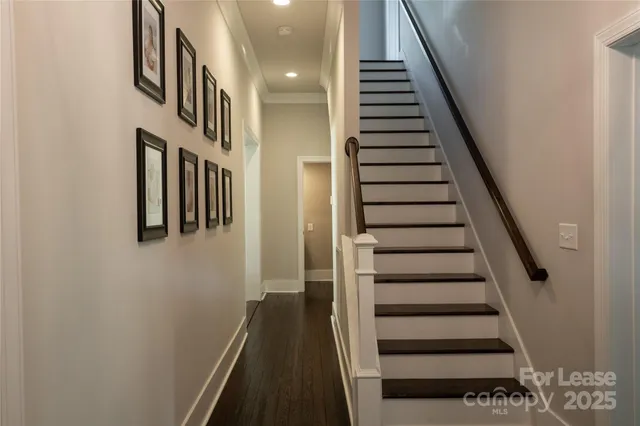 a view of entryway and gallery with wooden floor