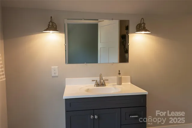a bathroom with a sink and mirror