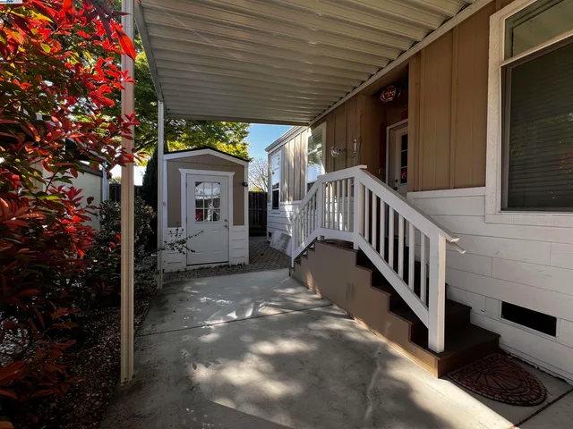 a view of a house with a small yard and floor to ceiling window