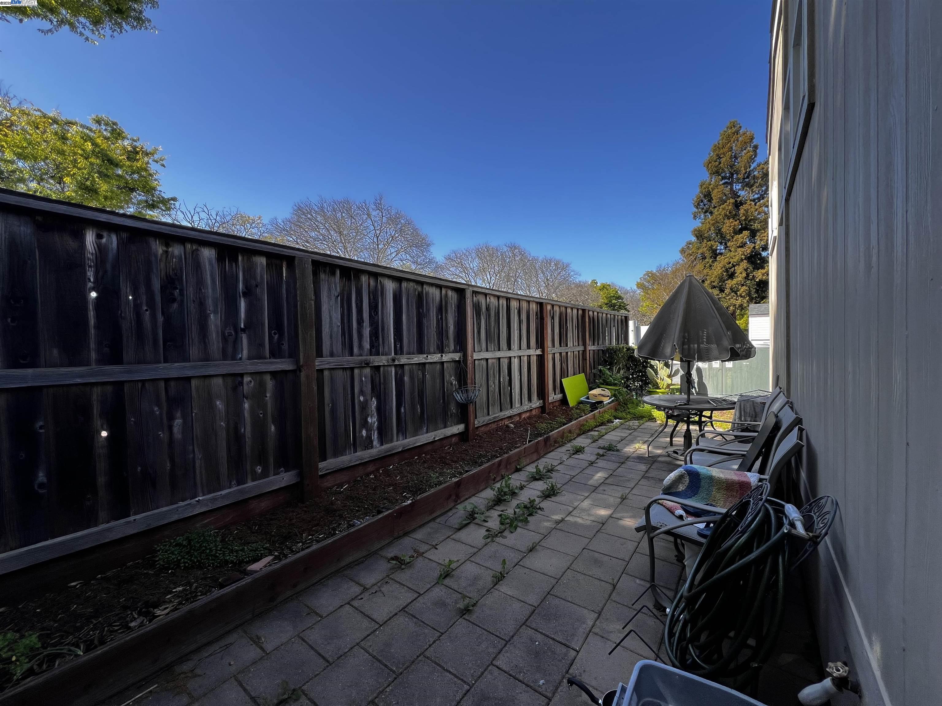 1050 Borregas Avenue, Unit 1 Sunnyvale, CA 94089 - Photo 13 of 13 a view of a backyard with wooden fence