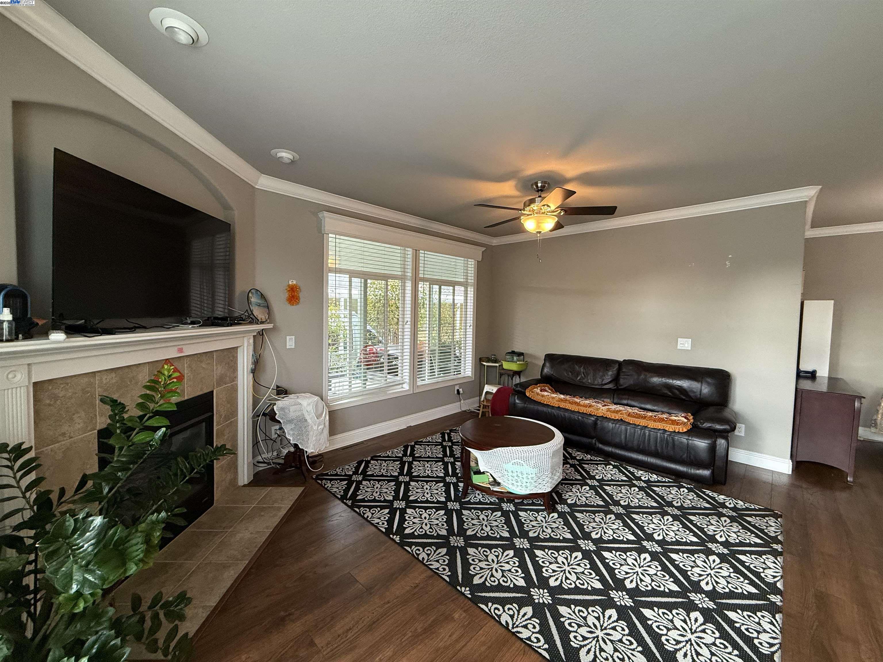 1050 Borregas Avenue, Unit 1 Sunnyvale, CA 94089 - Photo 3 of 13 a living room with furniture and a flat screen tv
