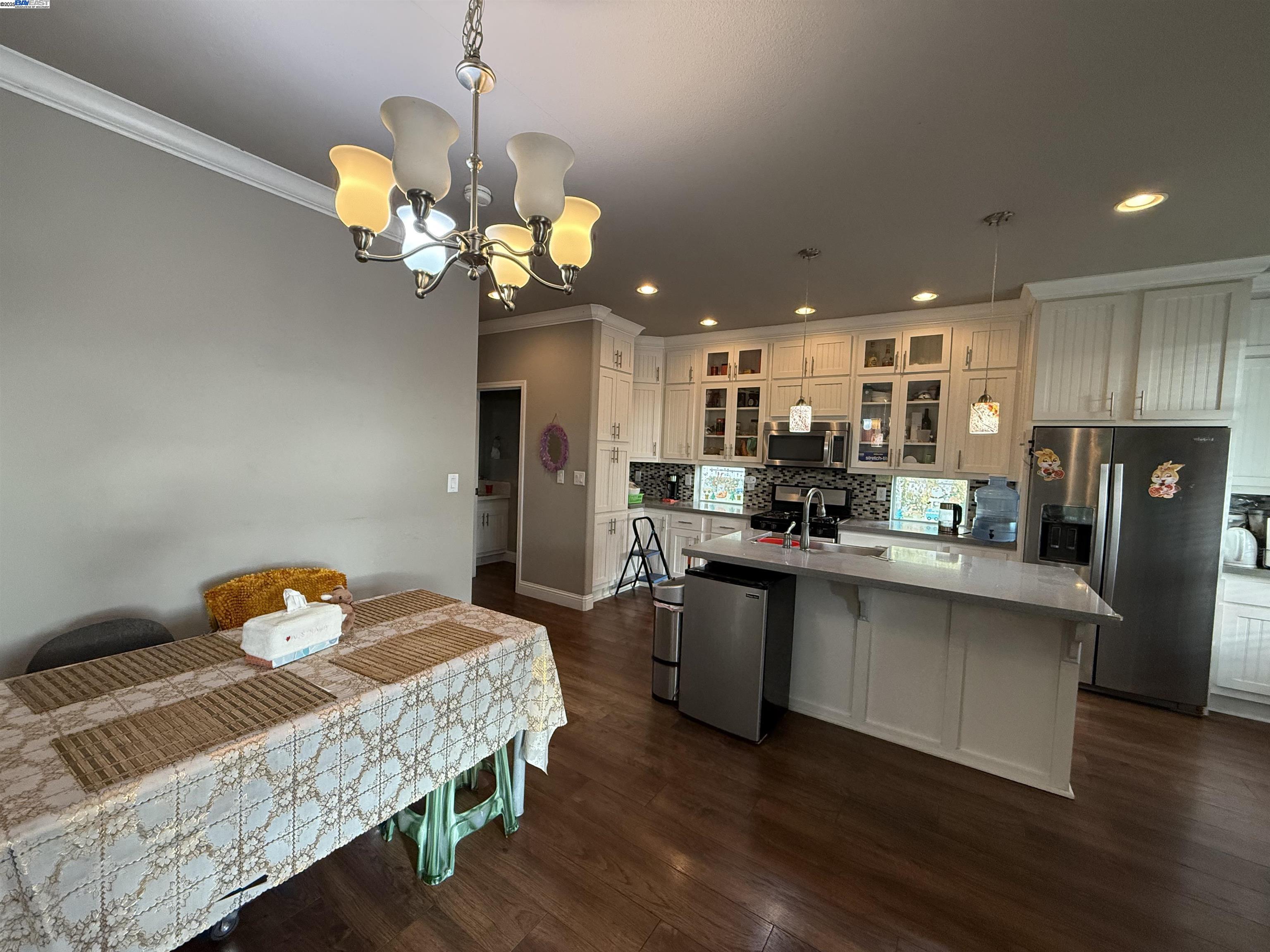 1050 Borregas Avenue, Unit 1 Sunnyvale, CA 94089 - Photo 4 of 13 a dining room filled chandelier and wooden floor