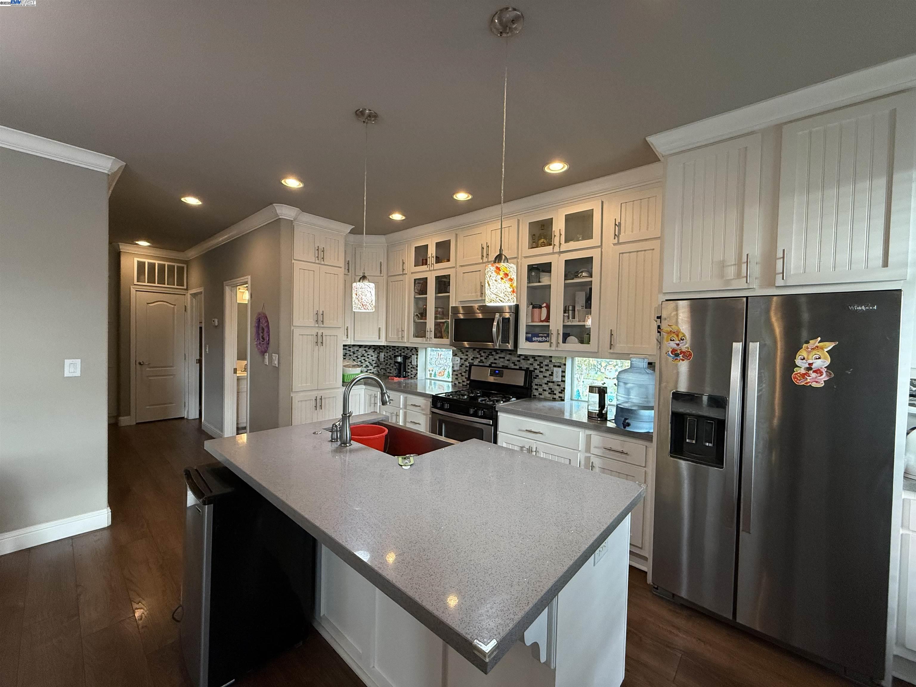 1050 Borregas Avenue, Unit 1 Sunnyvale, CA 94089 - Photo 5 of 13 a kitchen with stainless steel appliances granite countertop a refrigerator a sink dishwasher and a stove with wooden floor