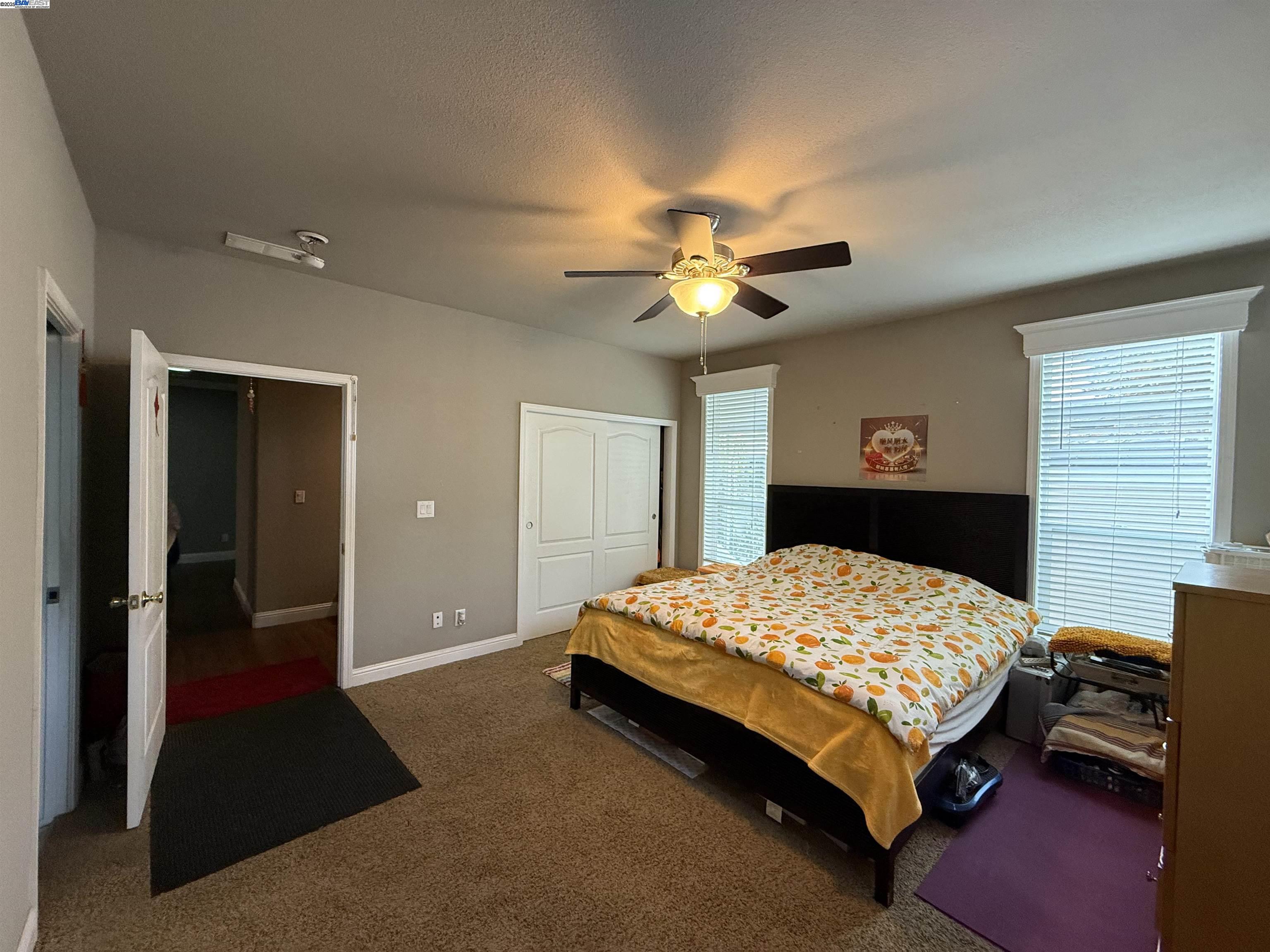 1050 Borregas Avenue, Unit 1 Sunnyvale, CA 94089 - Photo 6 of 13 a bedroom with a bed and a chandelier