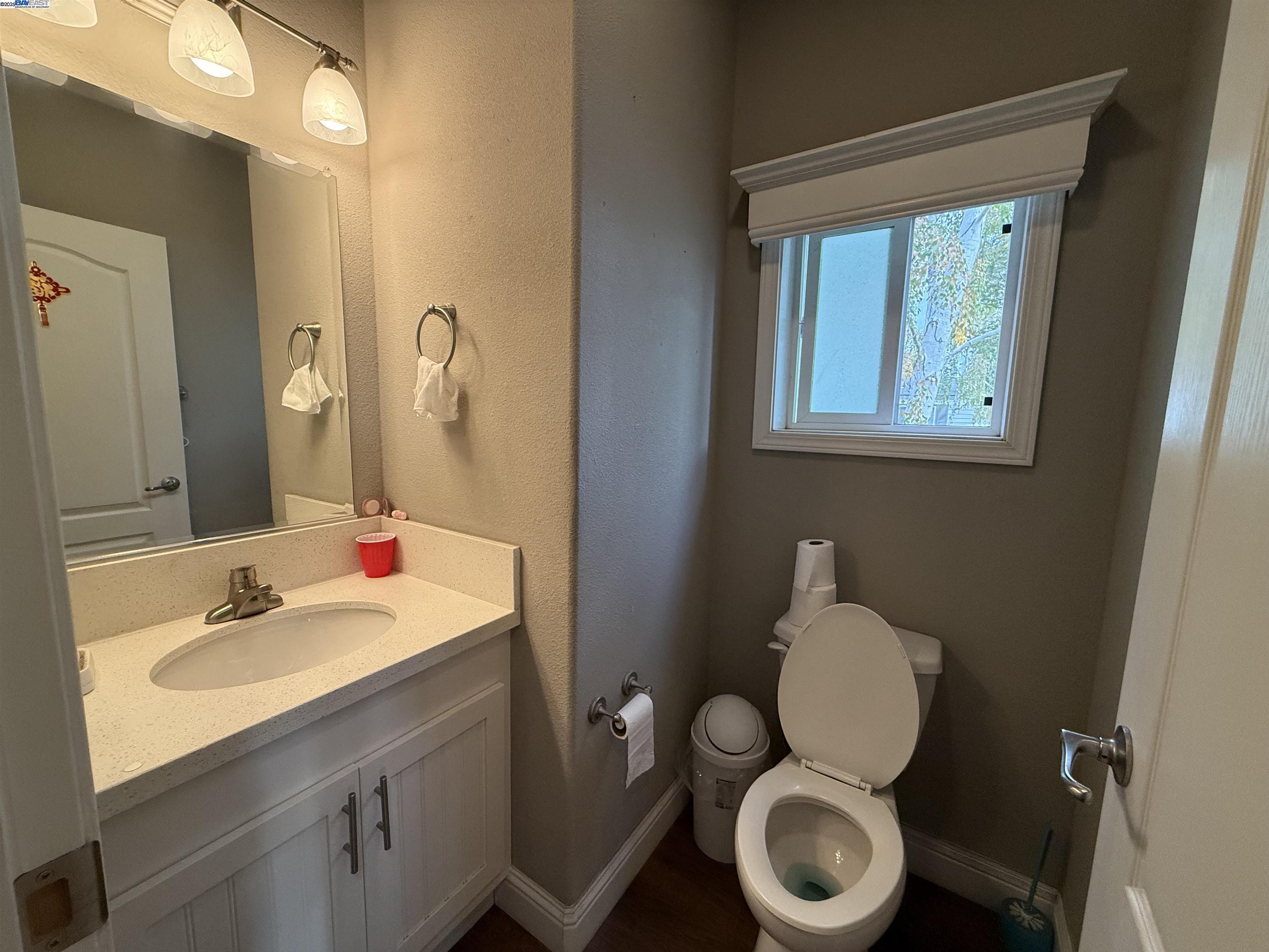 1050 Borregas Avenue, Unit 1 Sunnyvale, CA 94089 - Photo 7 of 13 a bathroom with a toilet a sink and mirror