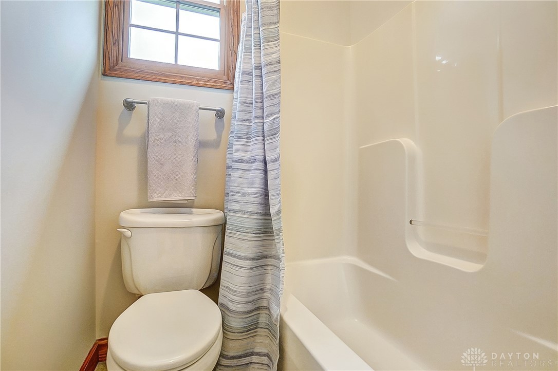 1540 Jasper Road Xenia, OH 45385 - Photo 37 of 91 This bathroom features a full tub and shower, with a window offering natural light.