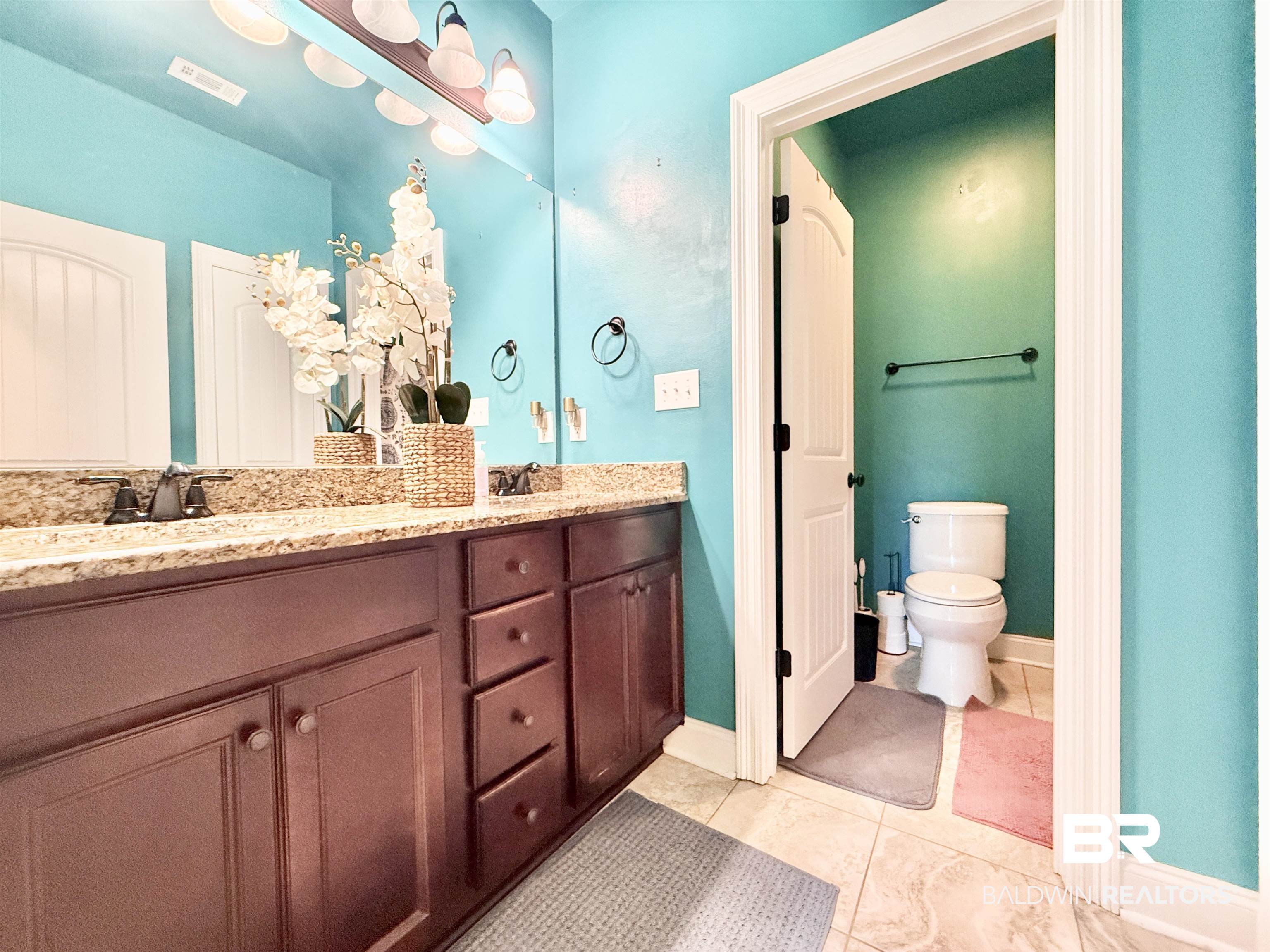 7011 Rocky Rd Loop Gulf Shores, AL 36542 - Photo 31 of 66 Full bath with double vanity and light tile patterned floors