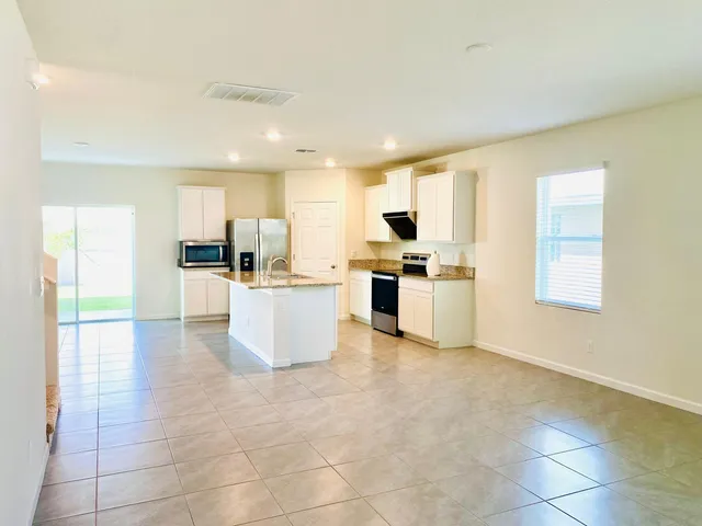 a kitchen with stainless steel appliances a refrigerator sink and cabinets