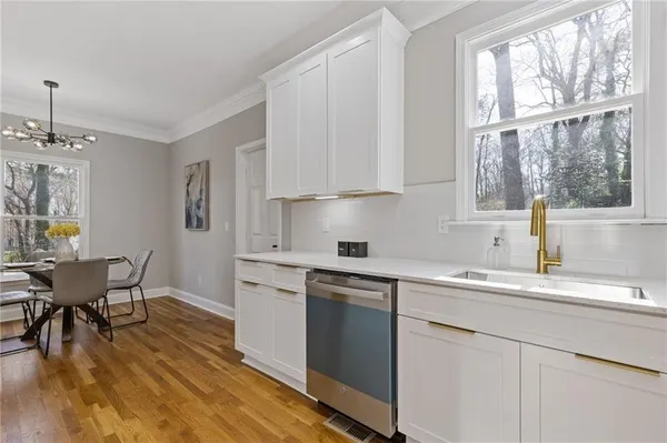 a kitchen with a sink cabinets and window