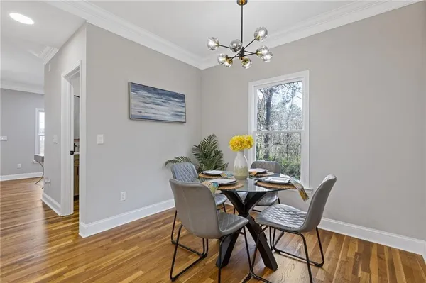 a view of a dining room with furniture and wooden floor