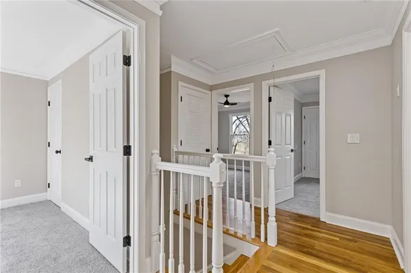 a view of a hallway with wooden floor