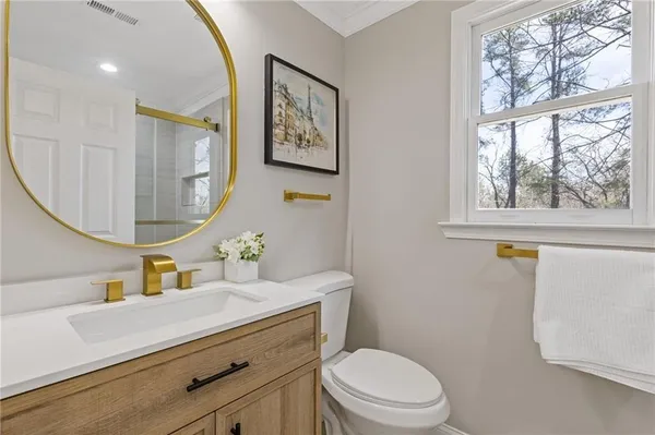 a bathroom with a sink a mirror and a toilet