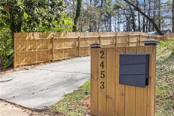 a view of a wooden fence and trees