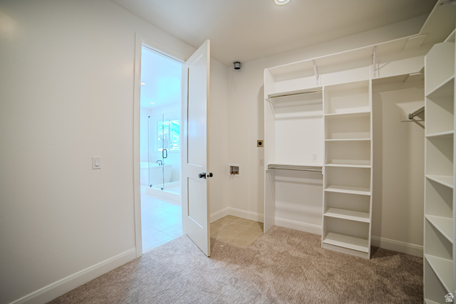 223 South Cottonwood Road, Unit 7501 Vineyard, UT 84059 - Photo 28 of 45 Walk-in closet featuring built-in shelving, dual hanging rods, and neutral-toned carpeting