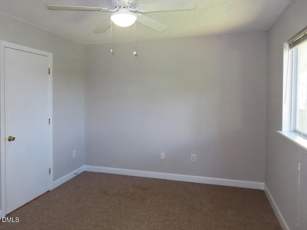 303 Smith Level Road, Unit B31 Chapel Hill, NC 27516 - Photo 14 of 20 an empty room with a window and a fan