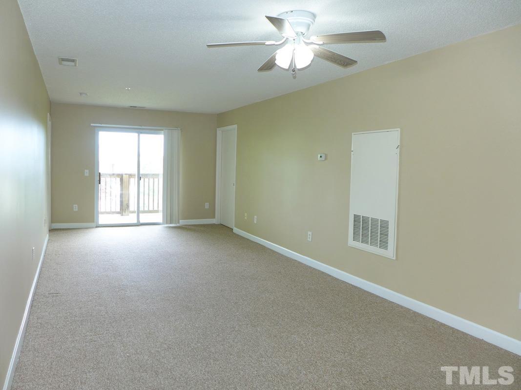 303 Smith Level Road, Unit B31 Chapel Hill, NC 27516 - Photo 2 of 20 an empty room with a window and a fan