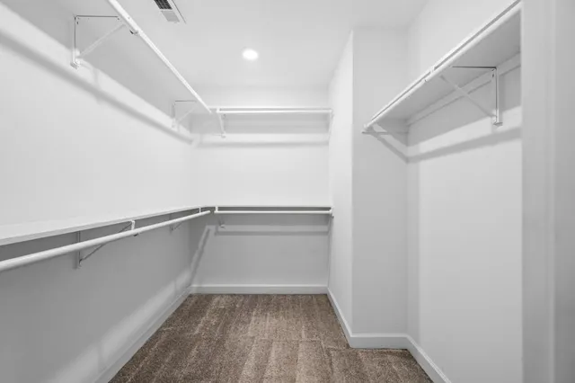 a bathroom with a granite countertop sink toilet mirror and shower