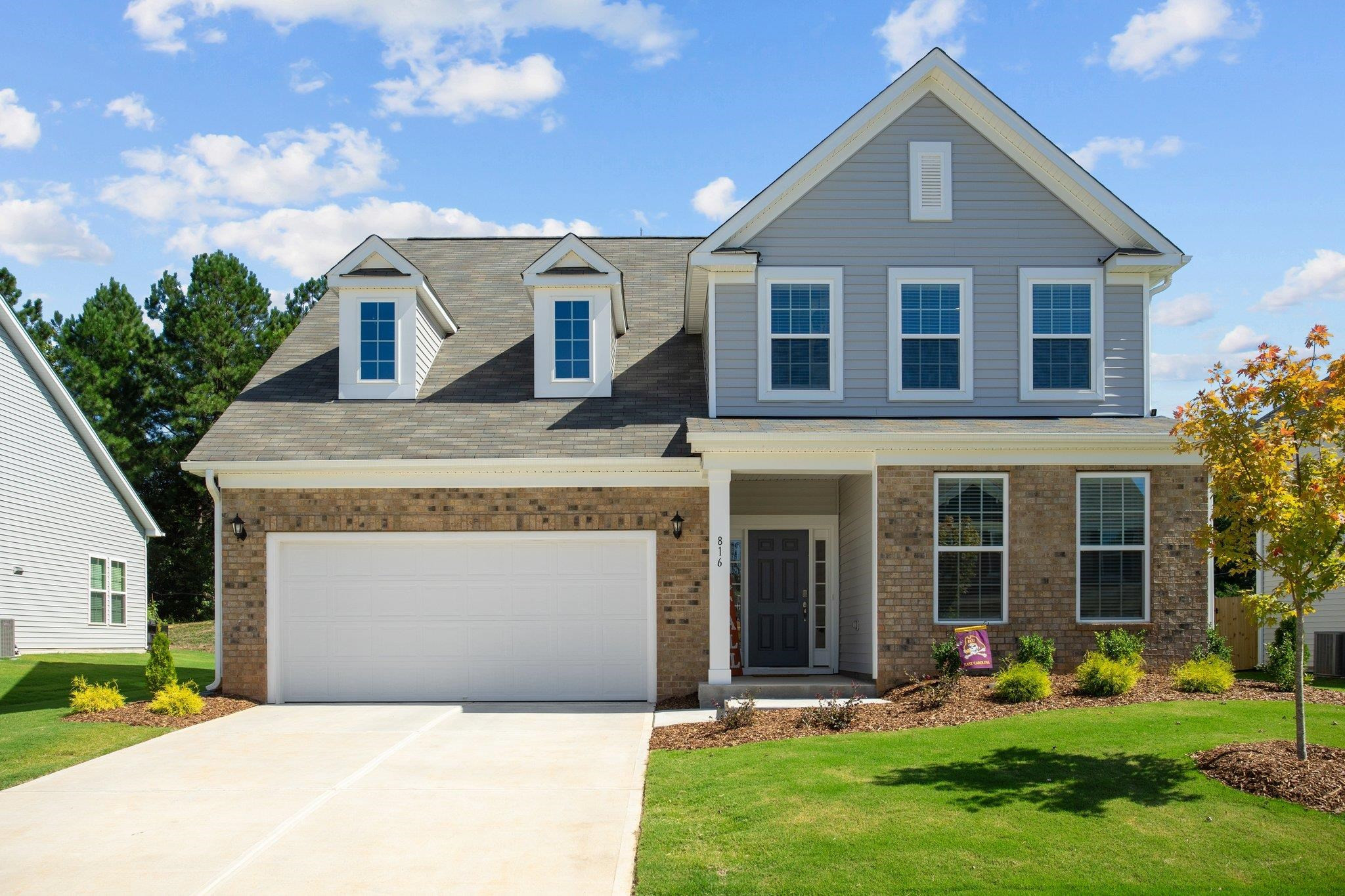 816 Heartpine Drive Mebane, NC 27302 - Photo 1 of 56 a front view of a house with a yard and garage