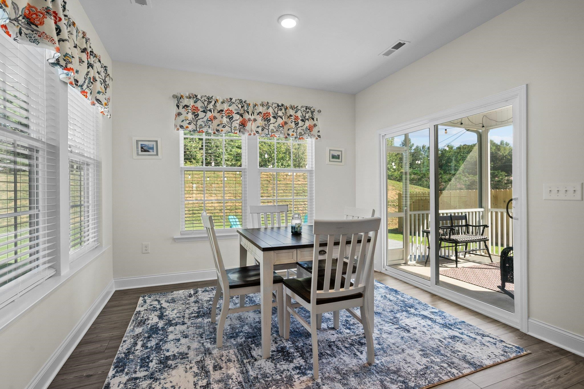 816 Heartpine Drive Mebane, NC 27302 - Photo 20 of 56 a view of a dining room with furniture window and wooden floor