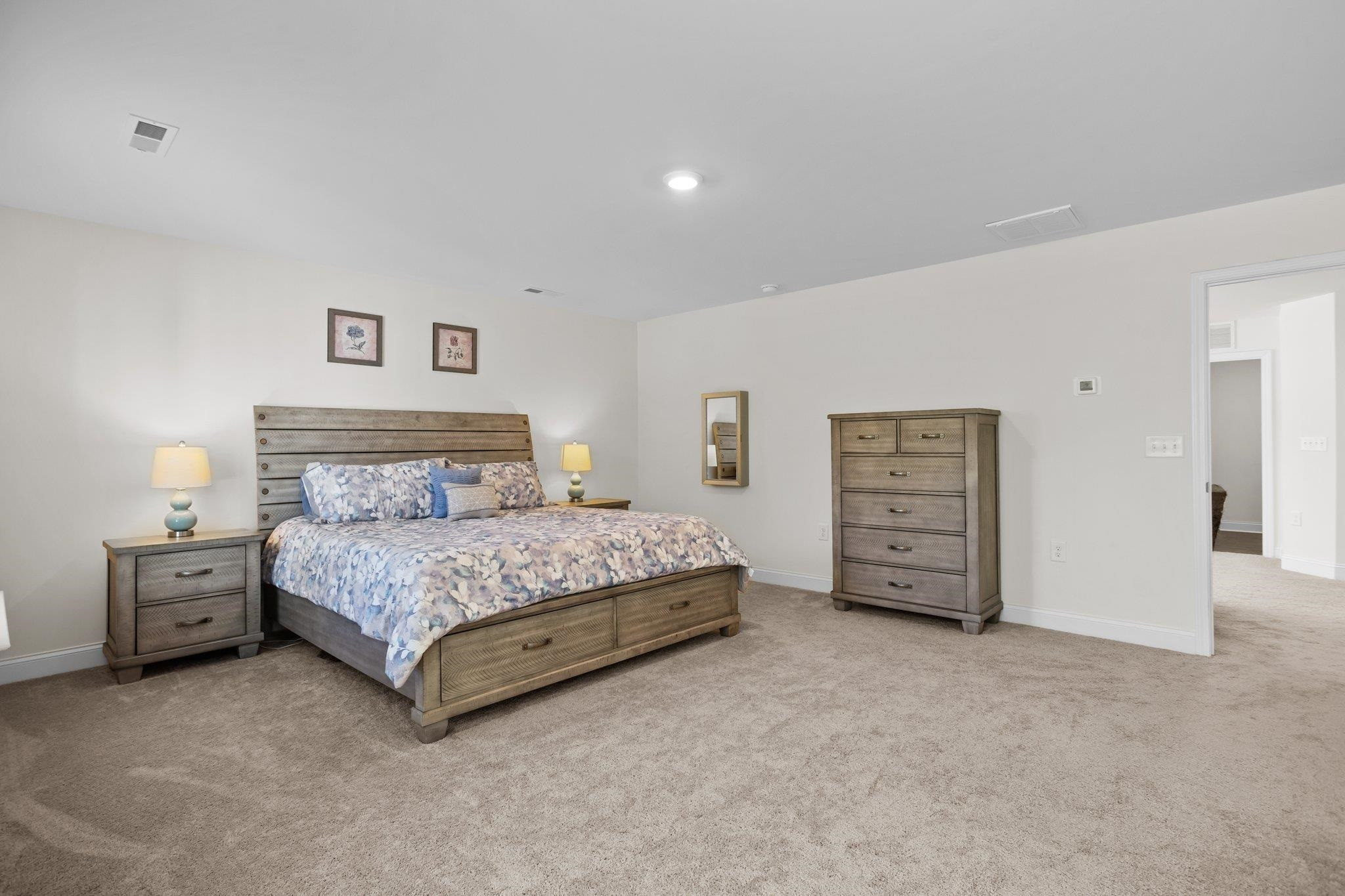 816 Heartpine Drive Mebane, NC 27302 - Photo 28 of 56 a spacious bedroom with a bed and a cabinets