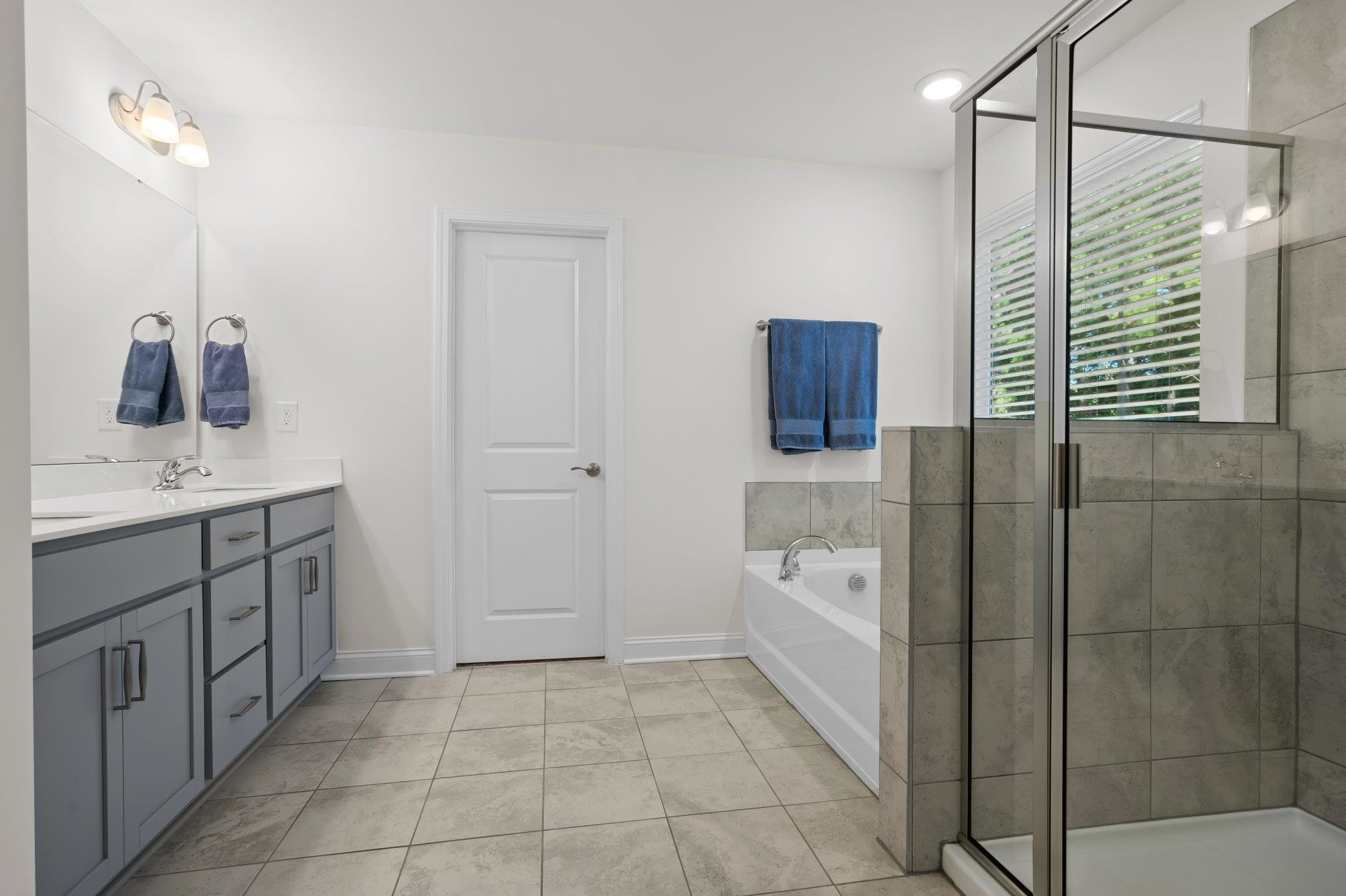816 Heartpine Drive Mebane, NC 27302 - Photo 32 of 56 a spacious bathroom with a bathtub sink and mirror