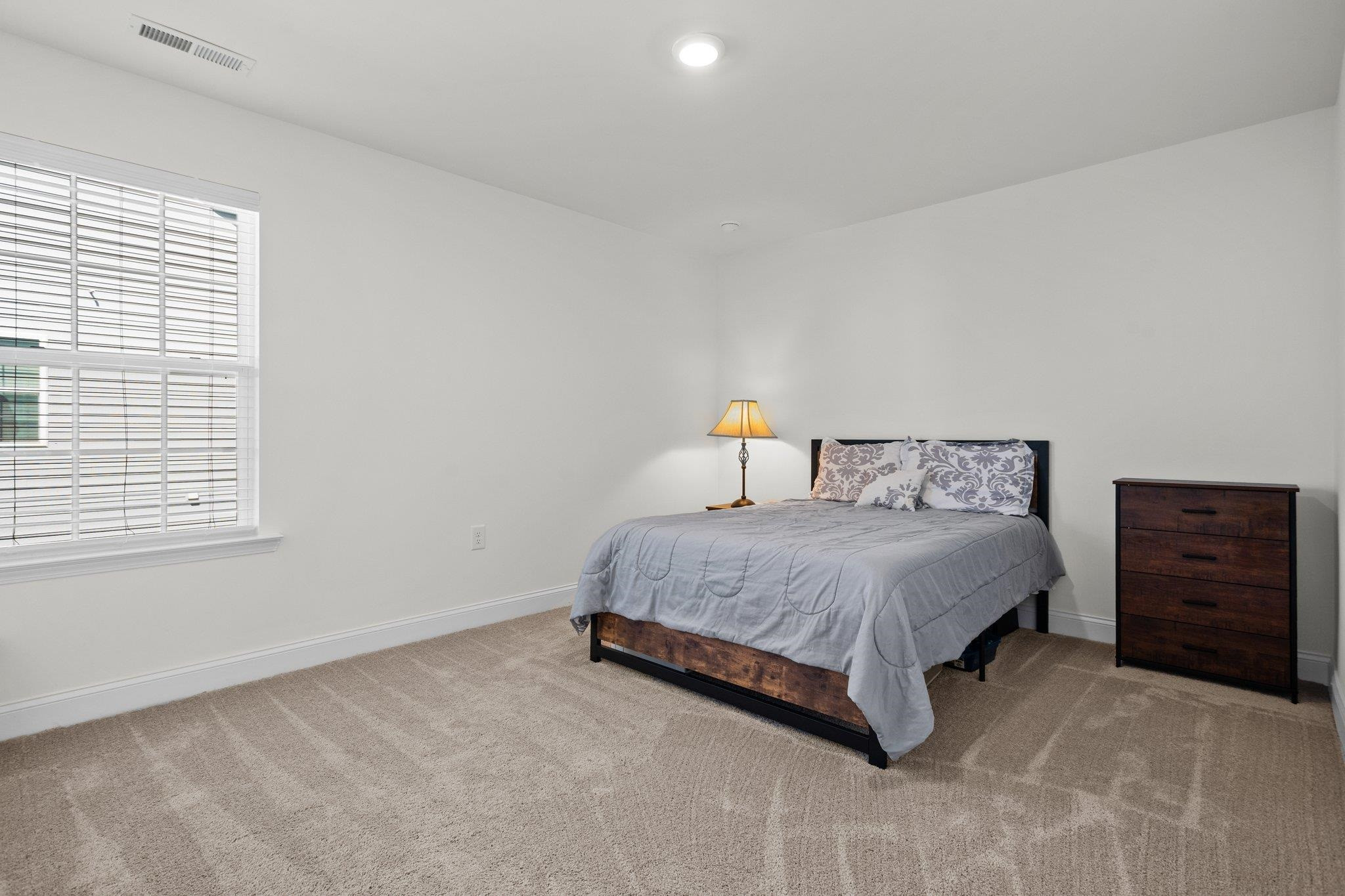 816 Heartpine Drive Mebane, NC 27302 - Photo 39 of 56 a bedroom with a bed and dresser