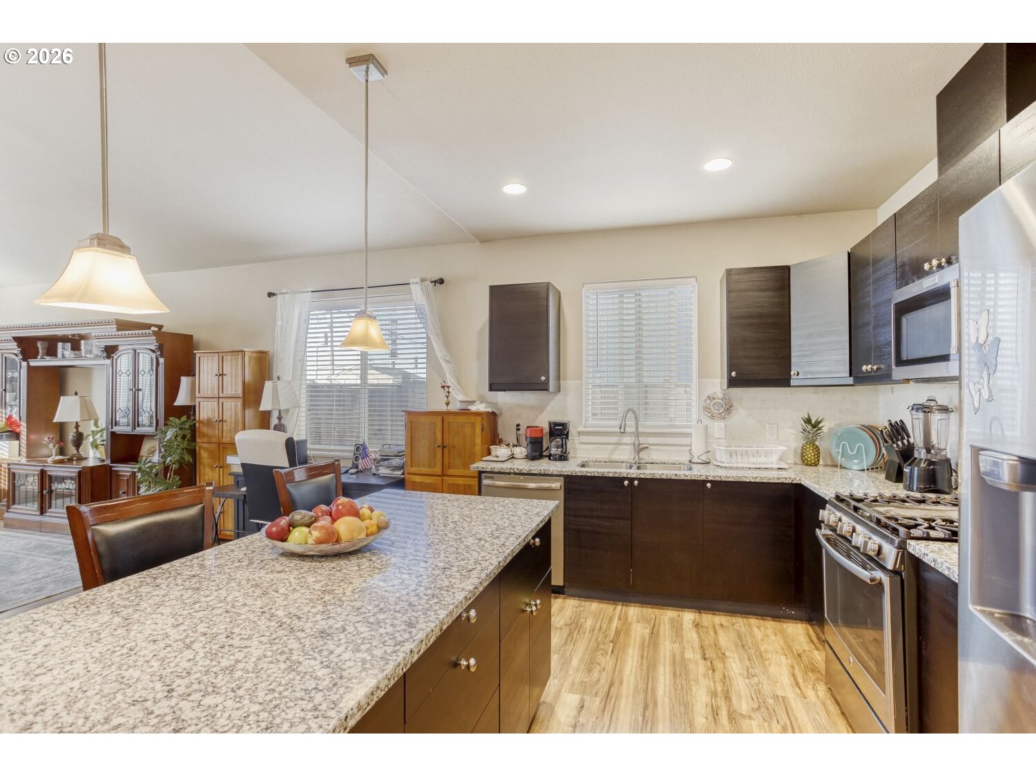 20845 Southwest Eggert Way Beaverton, OR 97078 - Photo 9 of 28 a kitchen with sink a stove and chairs