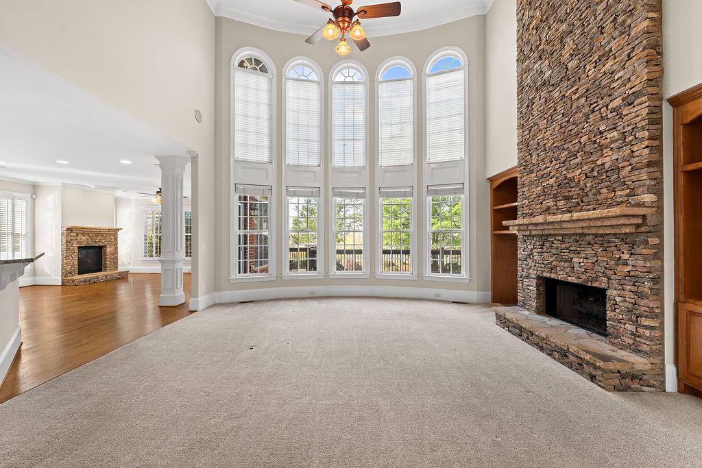 1037 Windermere Crossing Cumming, GA 30041 - Photo 12 of 95 a view of an empty room with a fireplace and a window