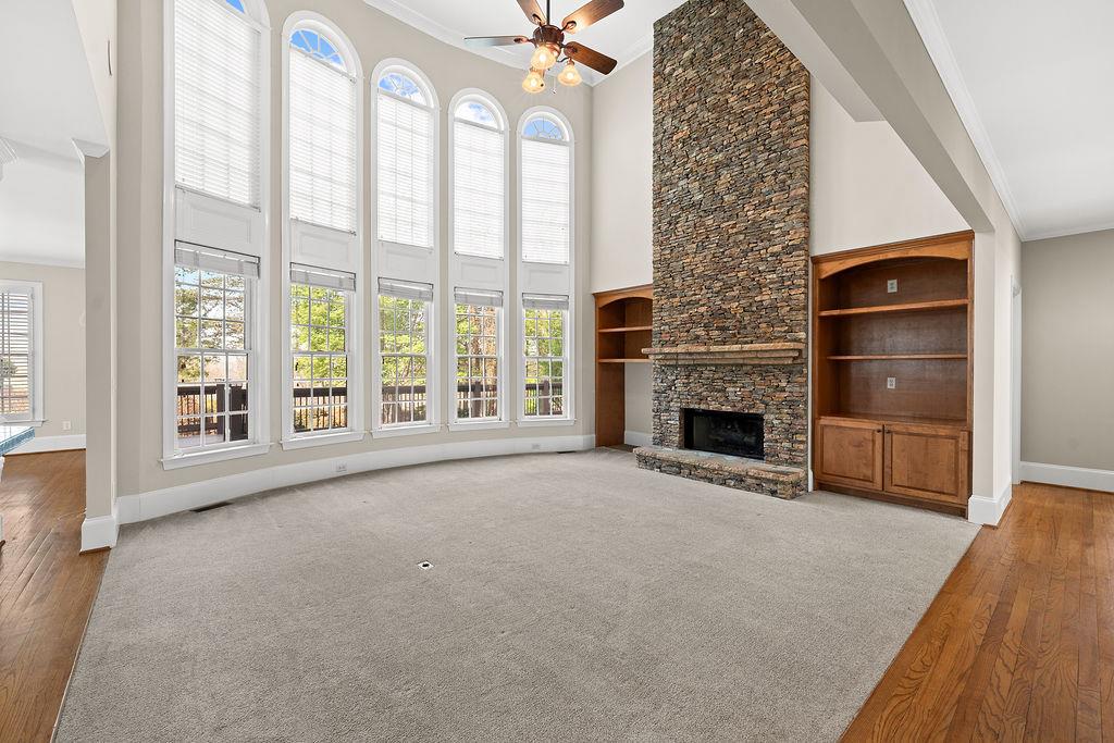 1037 Windermere Crossing Cumming, GA 30041 - Photo 13 of 95 a view of an empty room with a fireplace and a window