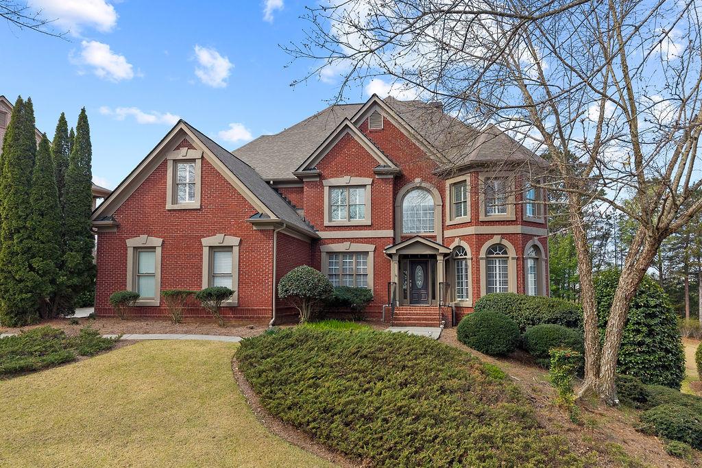 1037 Windermere Crossing Cumming, GA 30041 - Photo 2 of 95 a front view of a house with a yard and garage