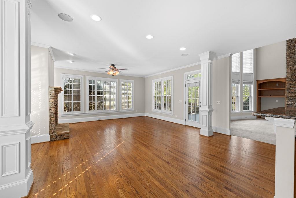 1037 Windermere Crossing Cumming, GA 30041 - Photo 24 of 95 a view of an empty room with wooden floor and a window