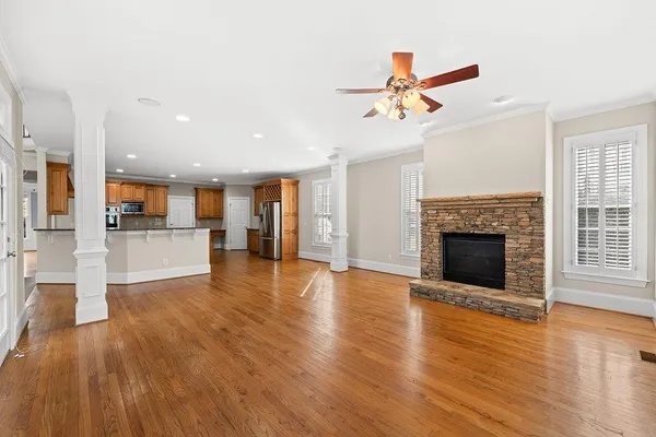 a view of an empty room with window and fireplace