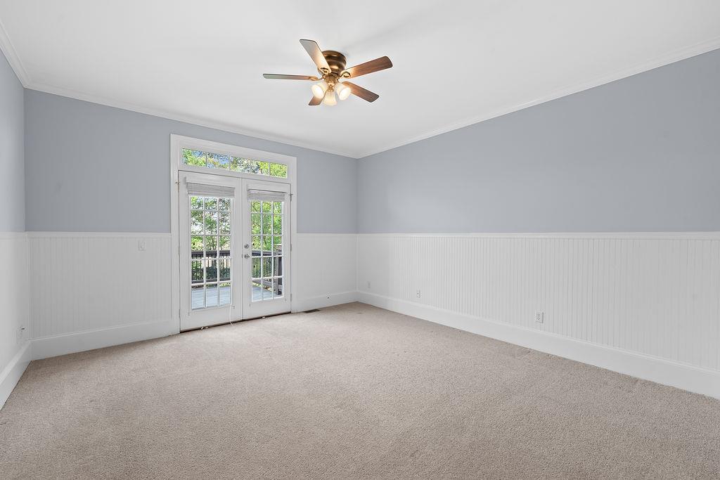 1037 Windermere Crossing Cumming, GA 30041 - Photo 30 of 95 an empty room with windows and ceiling fan