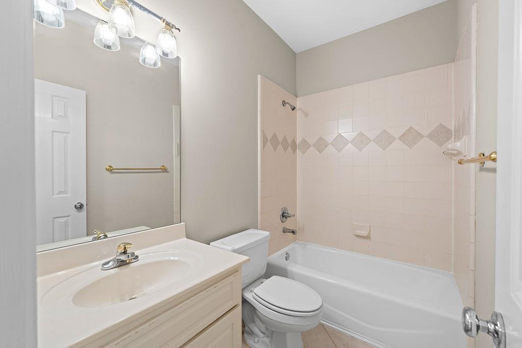 1037 Windermere Crossing Cumming, GA 30041 - Photo 49 of 95 a bathroom with a bathtub shower sink vanity mirror and toilet