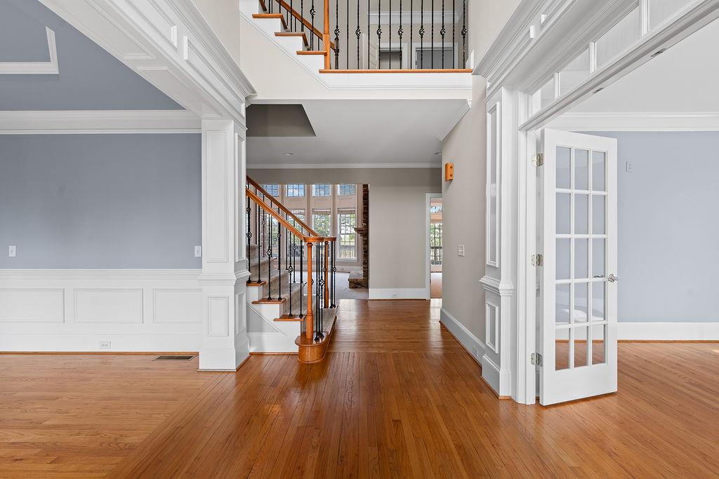 1037 Windermere Crossing Cumming, GA 30041 - Photo 5 of 95 a view of a hallway with wooden floor and windows