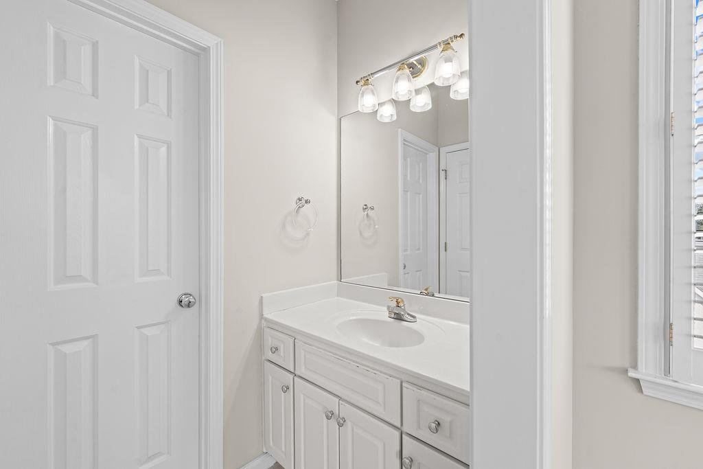 1037 Windermere Crossing Cumming, GA 30041 - Photo 58 of 95 a bathroom with a sink and a mirror